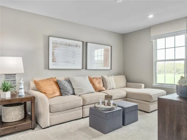 a living room with furniture large window and a lamp