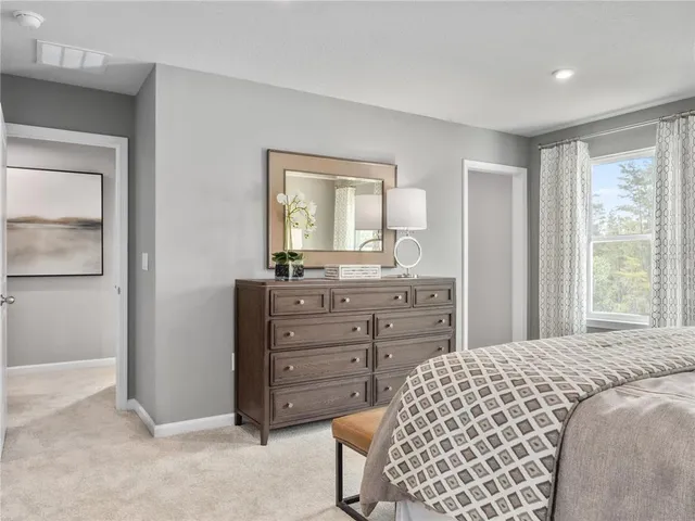 a bedroom with a bed and a dresser