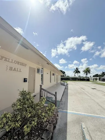 a view of a house with pool and sitting area