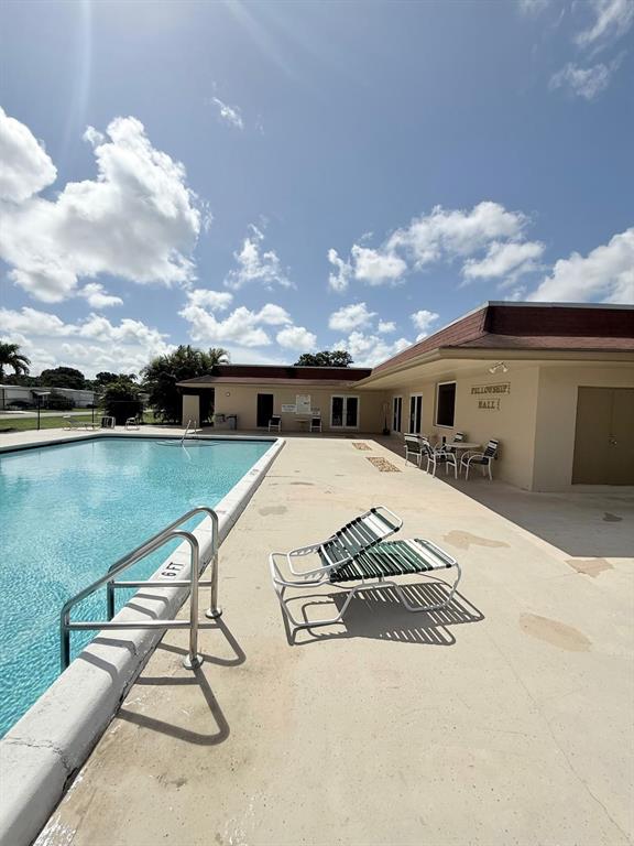 2090 Southwest 85th Avenue Davie, FL 33324 - Photo 32 of 37 a view of swimming pool with a lounge chairs in front of balcony