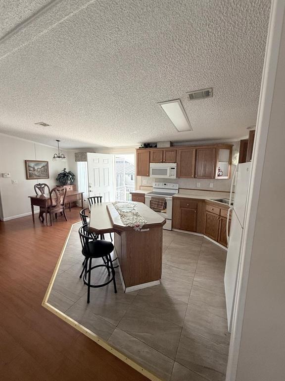 2090 Southwest 85th Avenue Davie, FL 33324 - Photo 4 of 37 a living room with stainless steel appliances kitchen island granite countertop furniture and a kitchen view