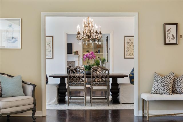 a view of a dining room with furniture and chandelier