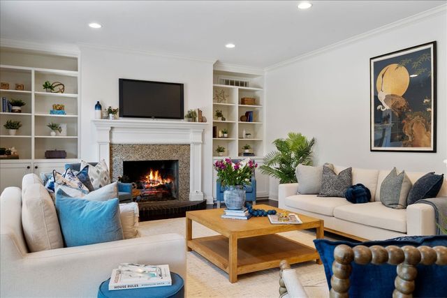 a living room with furniture fireplace and a flat screen tv
