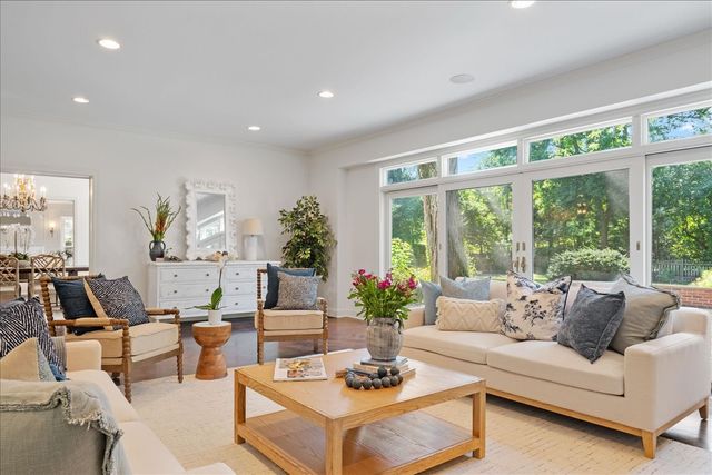 a living room with furniture and large windows