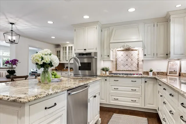 a kitchen with stainless steel appliances granite countertop a sink and cabinets