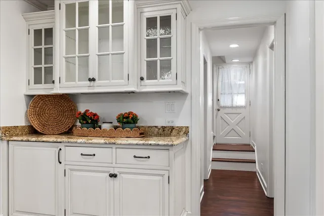 a view of white cabinets and wooden floor