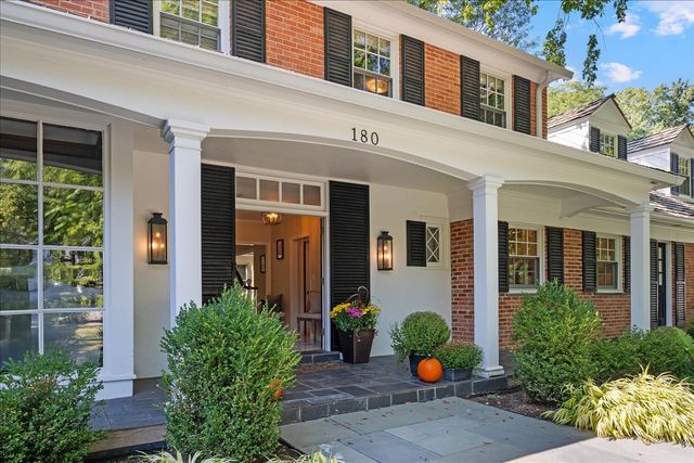a front view of a house having outdoor seating