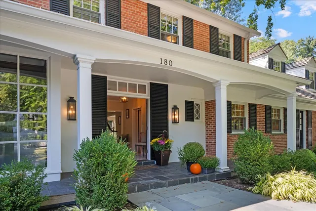 a front view of a house having outdoor seating