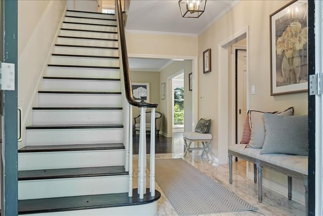 a view of entryway and hall with wooden floor