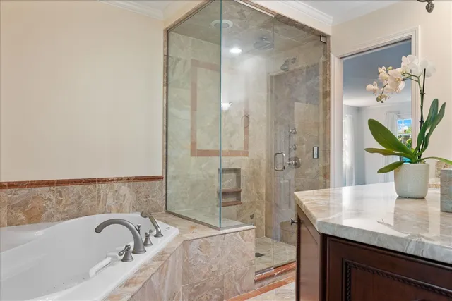 a bath room with a granite countertop sink and a bathtub