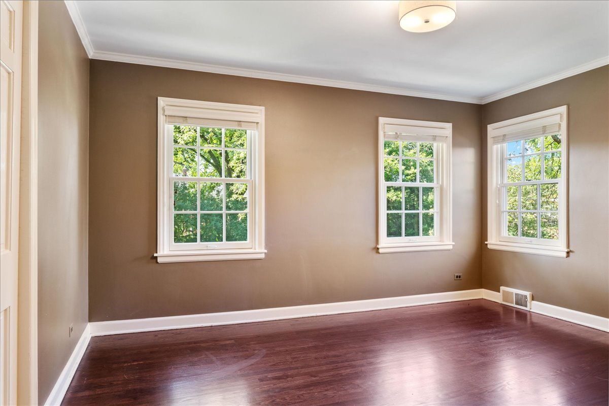 180 Apple Tree Road Winnetka, IL 60093 - Photo 36 of 49 an empty room with wooden floor and windows