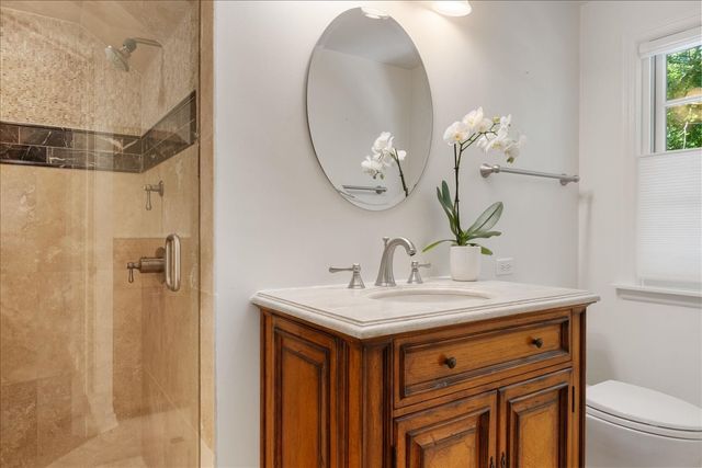a bathroom with a sink a toilet and a mirror