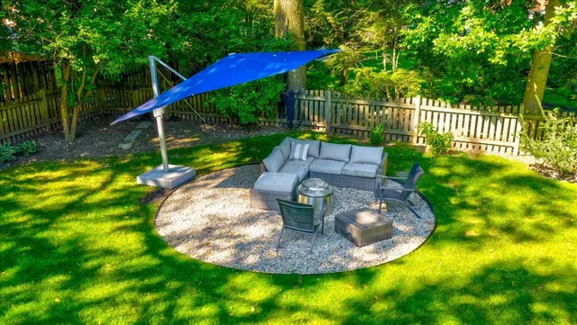 a view of a swimming pool with a patio and a garden
