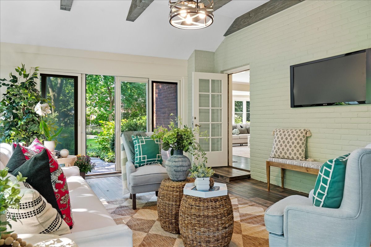 180 Apple Tree Road Winnetka, IL 60093 - Photo 10 of 49 a living room with furniture a flat screen tv and a large window