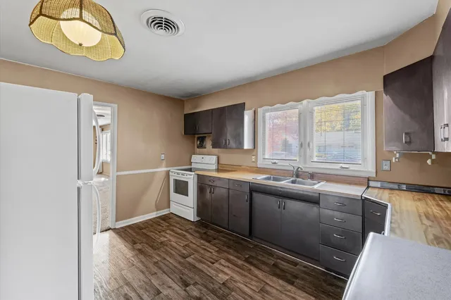 a kitchen with stainless steel appliances granite countertop a sink and cabinets