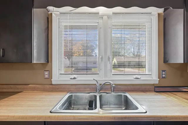 a kitchen with a sink cabinets and a window