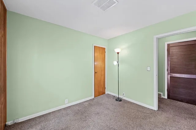 an empty room with closet area