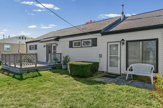 a backyard of a house with a garden and outdoor seating
