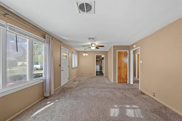 an empty room with windows and closet