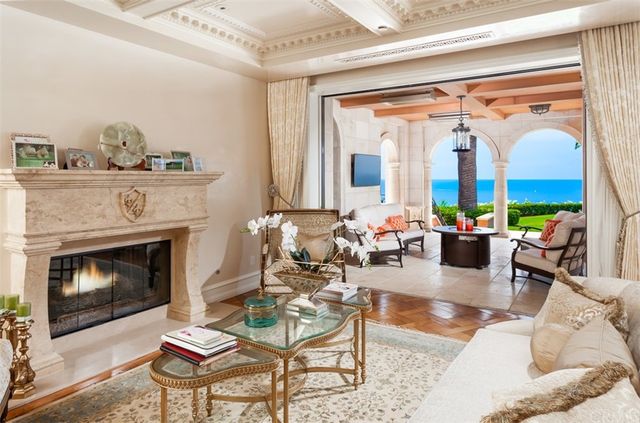 a kitchen with white cabinets and sink