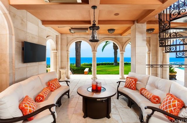 a view of a dining room with furniture and a chandelier