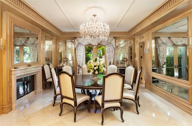 a living room with furniture a chandelier and large window