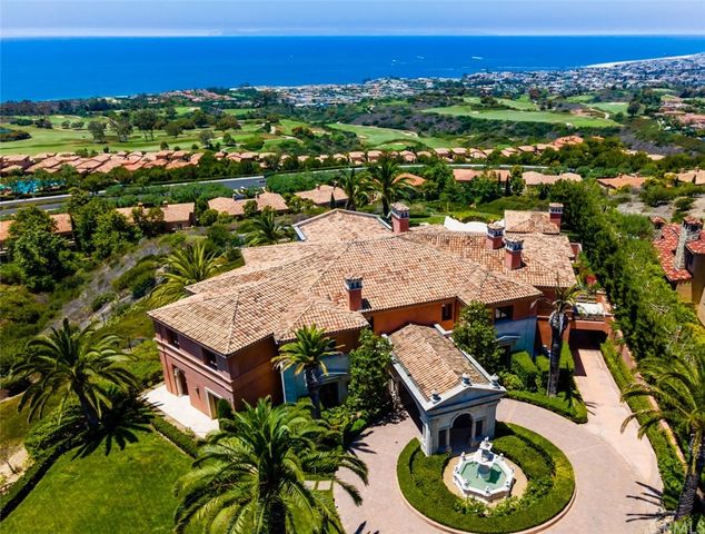 an aerial view of residential houses with outdoor space and swimming pool