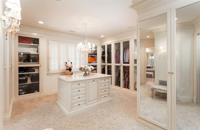 a view of swimming pool with a yard and palm trees