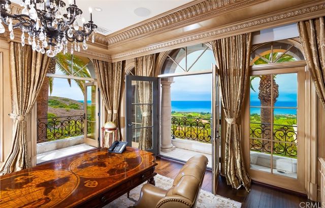 a front view of a house with a yard and potted plants