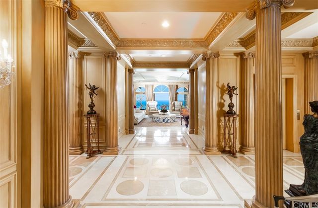 a living room with furniture a fireplace and a chandelier