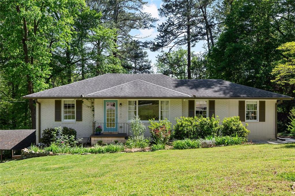 a front view of a house with a garden