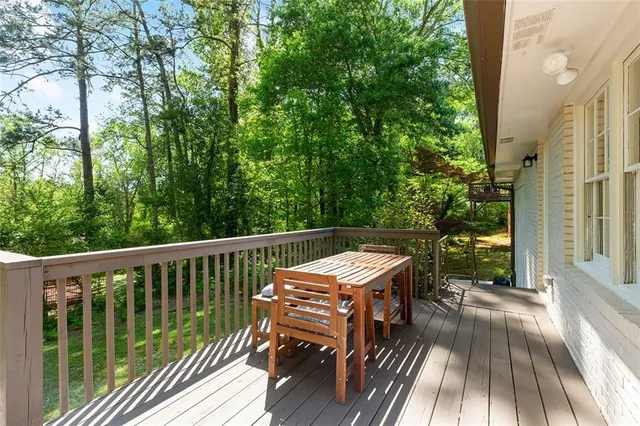a view of balcony with wooden floor and fence