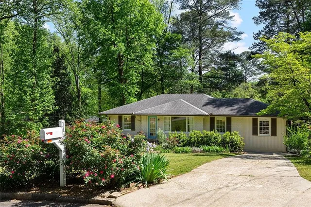 a front view of a house with yard and green space