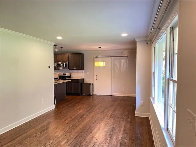 a view of kitchen with sink and refrigerator