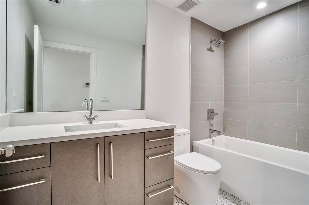 1408 South Alamo Road Rockwall, TX 75087 - Photo 31 of 40 a bathroom with a granite countertop sink toilet mirror and shower
