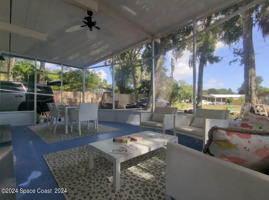 102 Vanguard Circle Cocoa, FL 32926 - Photo 1 of 14 a living room with patio furniture and a floor to ceiling window