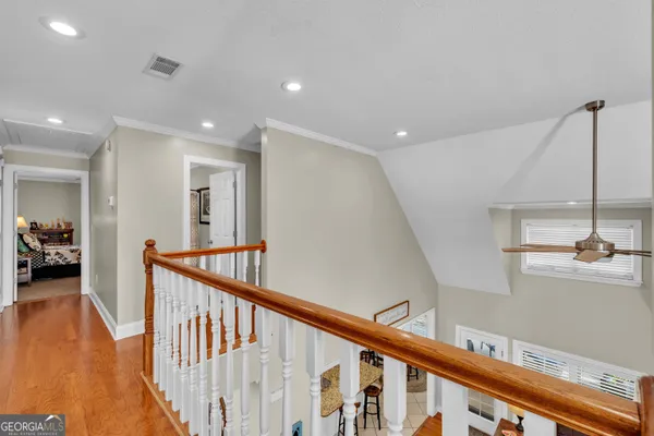 a view of a hallway with a livingroom and furniture