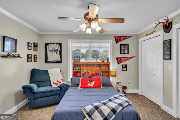 a living room with furniture and painting on the wall