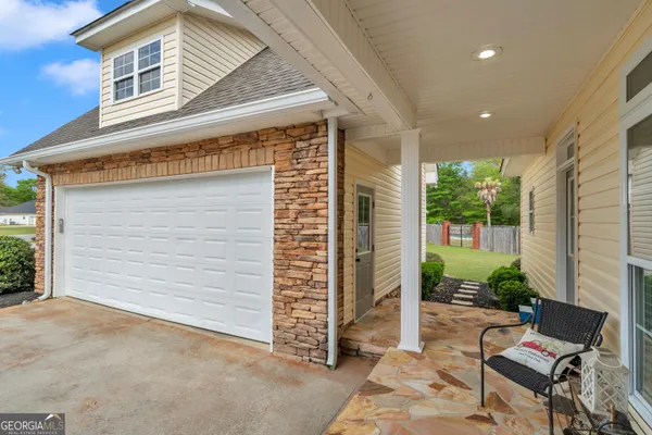 a view of backyard with a garden and chairs