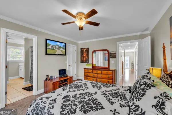 a bedroom with bed and wooden floor