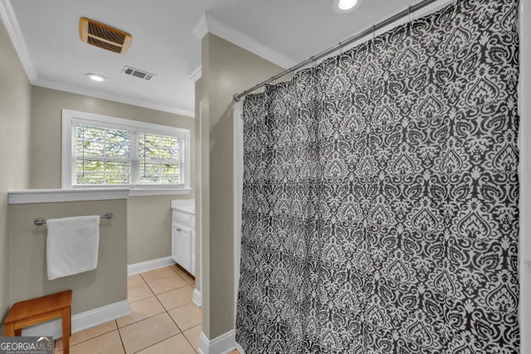 a bathroom with a shower curtain and a window
