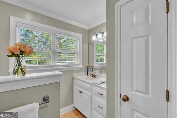 a bathroom with a sink a mirror and a window
