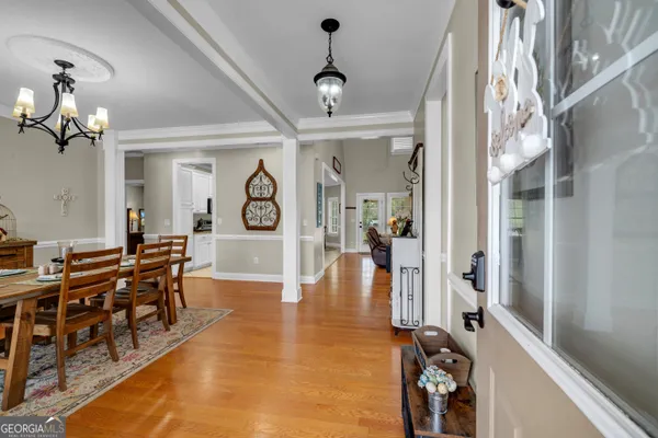 a view of a livingroom with furniture wooden floor and a chandelier