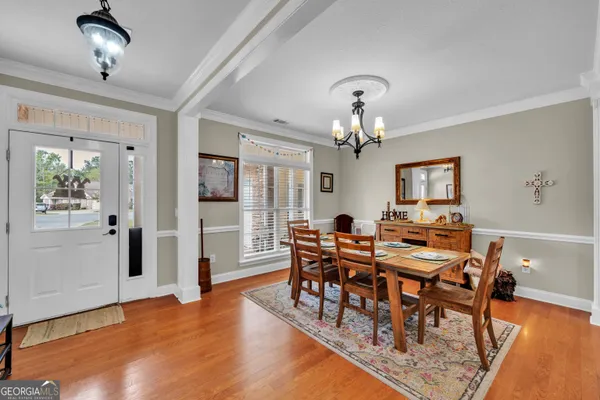 a view of a dining room with furniture and wooden floor
