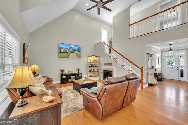 a living room with furniture and a wooden floor