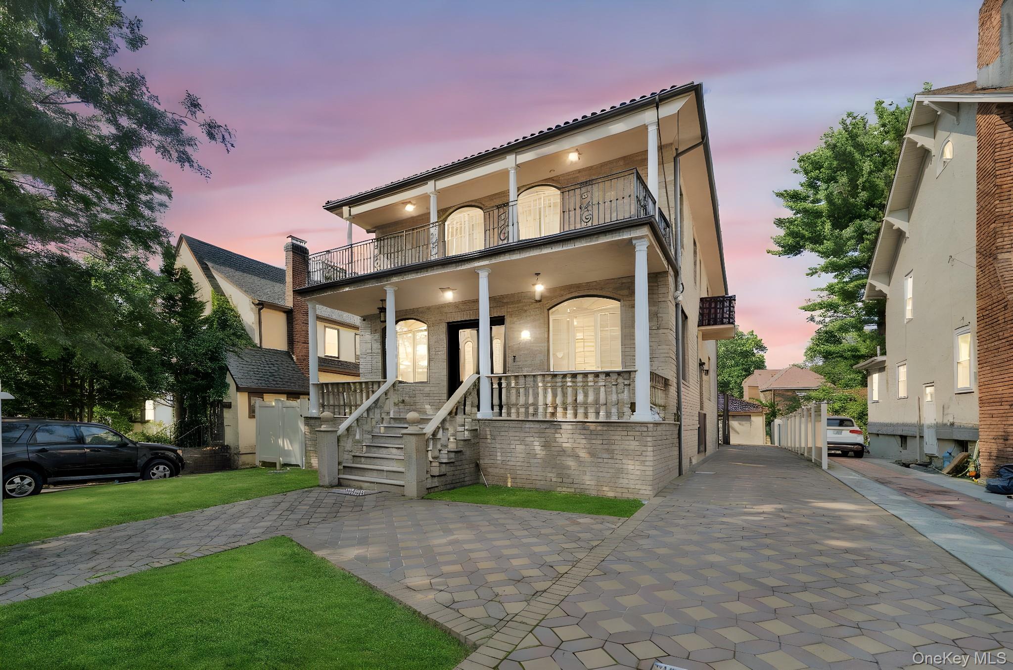 a front view of a house with a garden and plants