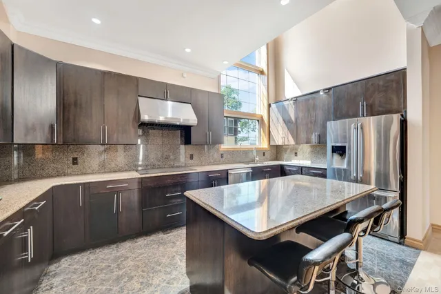 a kitchen with a table chairs sink and cabinets