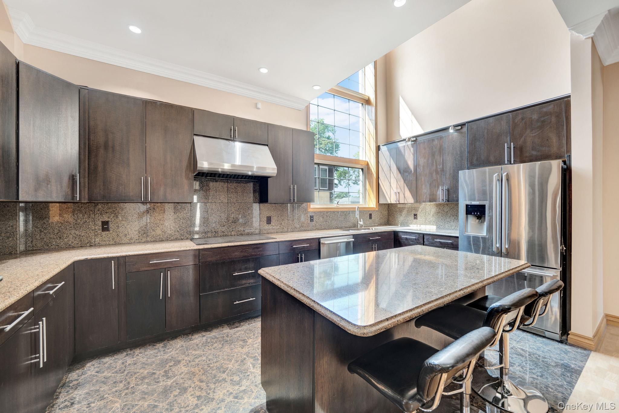84-29 Kendrick Place Queens, NY 11432 - Photo 12 of 50 a kitchen with a table chairs sink and cabinets