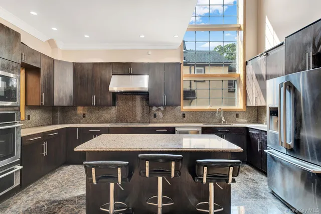 a kitchen with stainless steel appliances a sink stove and refrigerator