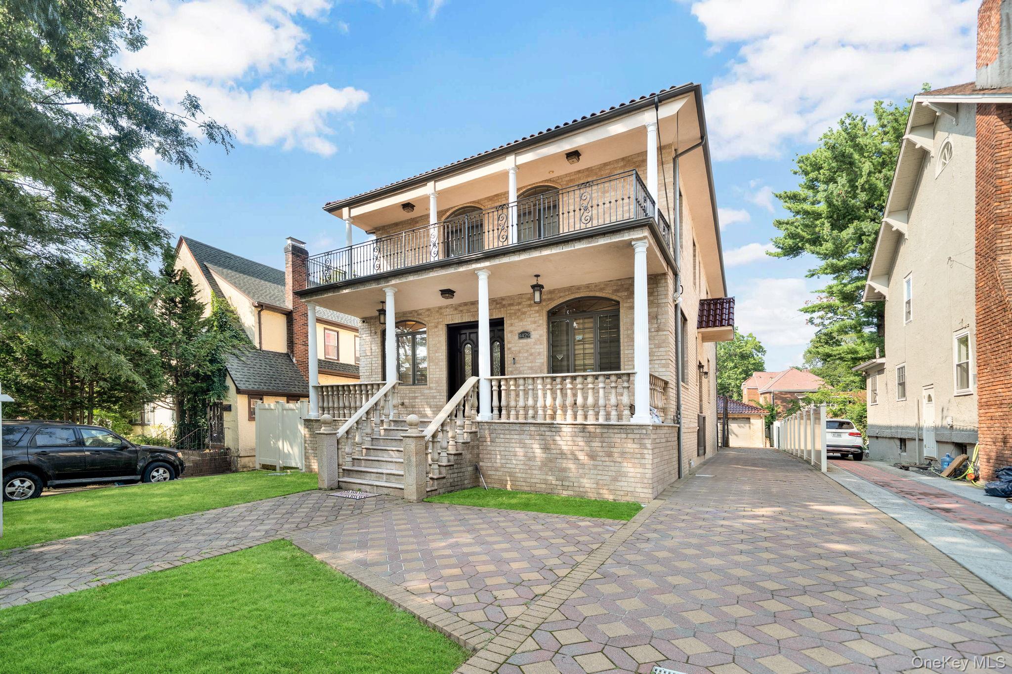 84-29 Kendrick Place Queens, NY 11432 - Photo 2 of 50 a front view of a house with a garden and bench